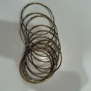 Stack of 12 gold bracelts